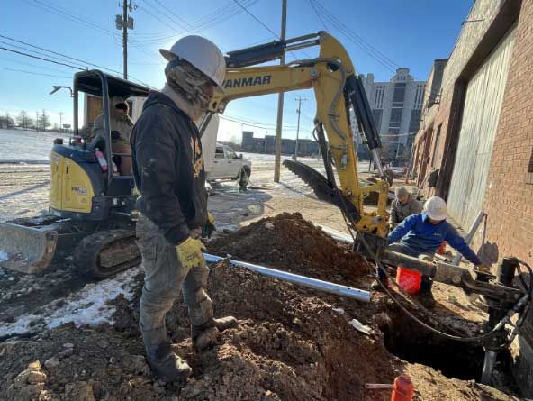 Excavator digging out for push piers in Chattanooga