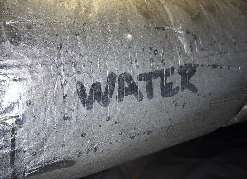 water written out in condensation on window